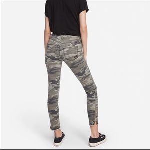 Mid-rise camo print jeans with ankle zippers.